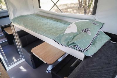 Folding top bunk above dinette 